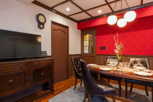 a dining room with a table and a tv at IROHA STAY HANEDA - Family-Friendly Home Stay near Haneda with Great Access to Tokyo & Yokohama in Tokyo