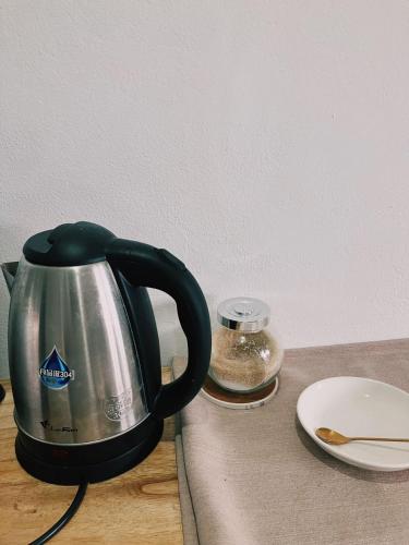 a tea kettle sitting on top of a counter at Venn Hostel in Vientiane