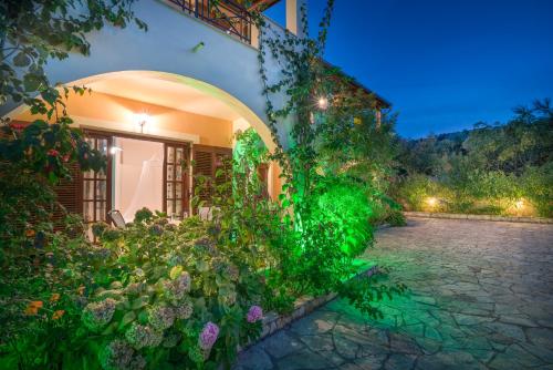 a garden in front of a house at night at Olga Studios in Vasilikos