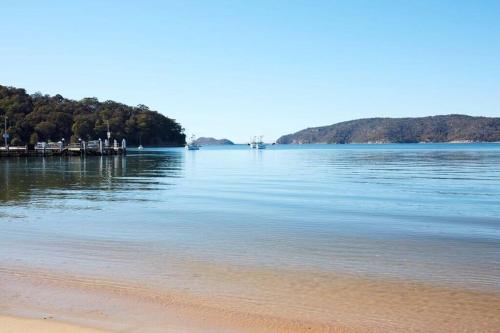 a view of a body of water with a beach at Absolute Beach Front House Panoramic Views in Patonga