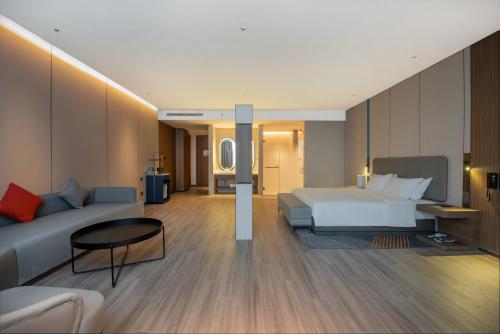 a hotel room with a bed and a couch at Holiday Inn Express Yinchuan Lanxi Valley Plaza by IHG in Yinchuan