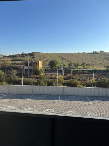 a parking lot with a view of a field at Sabo Apartment in Cluj-Napoca