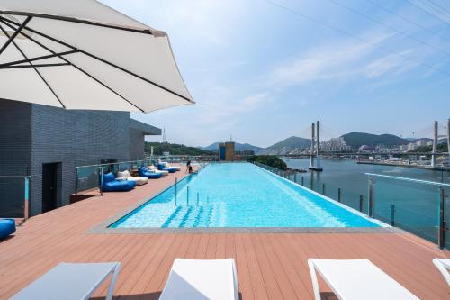 a swimming pool on the roof of a building at Yeosu OANDF Hotel in Yeosu