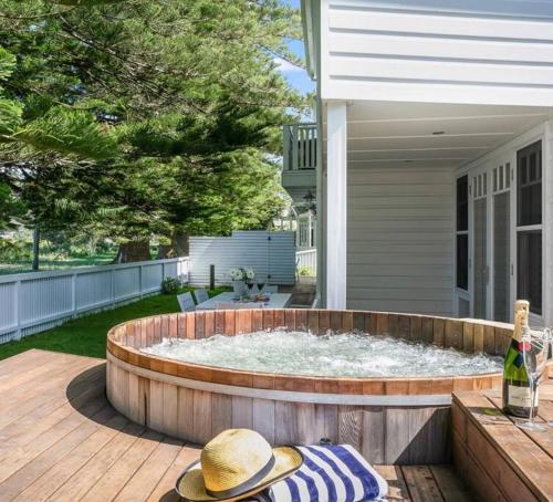 a large circular pool on a patio of a house at Beach Front House Outdoor Hot Tub Sauna in Patonga