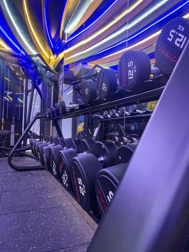 a row of rows of dumbbells in a gym at Cat Ba Paradise Hotel - Sky Bar & Massage in Cat Ba