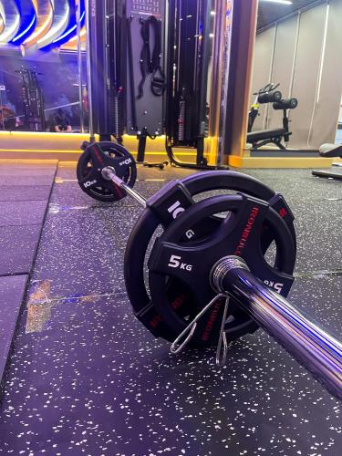 a gym with a weightlifting belt and weights at Cat Ba Paradise Hotel - Sky Bar & Massage in Cat Ba