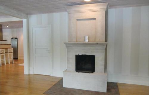 a living room with a fireplace and a door at Lovely Home In Tranås With Kitchen in Bjärsjö