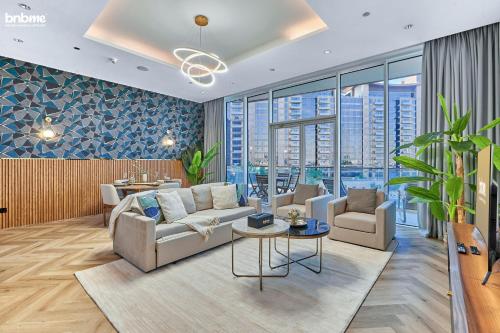 a living room with a couch and chairs and windows at bnbmehomes - Tiara Tanzanite in Dubai