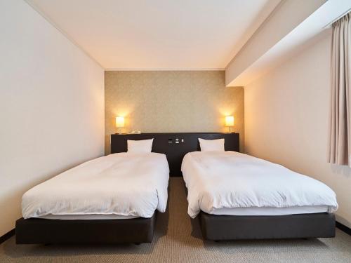 Katil atau katil-katil dalam bilik di Hotel Global View Sapporo Old Hotel Royal Stay Sapporo