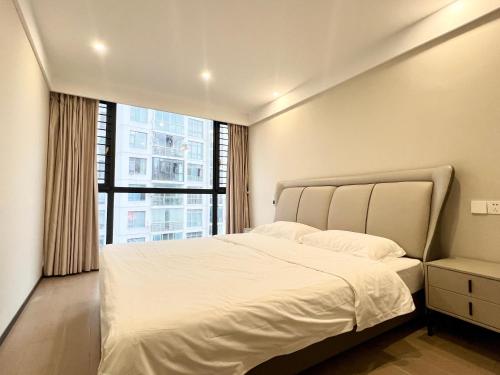 Ένα ή περισσότερα κρεβάτια σε δωμάτιο στο Suzhou Lakeside Sky Villa