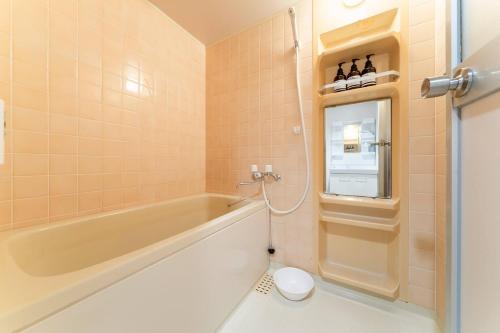 a bathroom with a tub and a toilet at Villa mitamura 303 VM33 in Tokyo