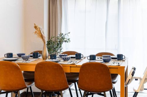 a dining room table with chairs and a large window at Villa mitamura 303 VM33 in Tokyo