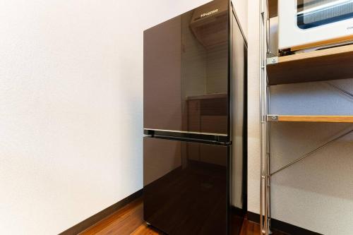 a refrigerator with a glass door in a kitchen at Villa mitamura 303 VM33 in Tokyo