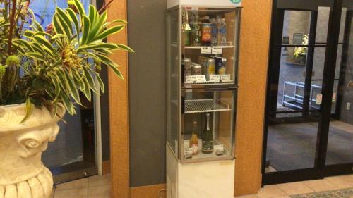 a display case in a store with bottles of alcohol at Blossom Hotel Hirosaki in Hirosaki
