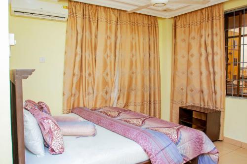 Un ou plusieurs lits dans un hébergement de l'établissement Sleep Inn Hotel - Kariakoo
