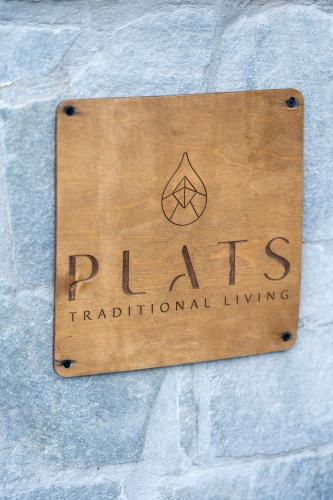 a sign that reads ribs traditional living on a stone wall at PLATS Traditional Living in Dáfni