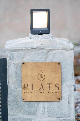a sign on a stone wall with a television on it at PLATS Traditional Living in Dáfni
