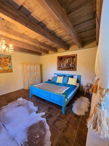 a bedroom with a blue bed in a room at Villa Lucia in Banská Štiavnica