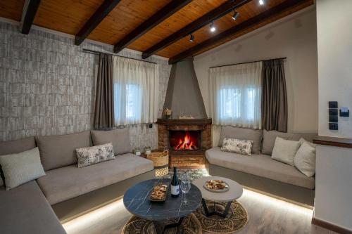 a living room with a couch and a fireplace at PLATS Traditional Living in Dáfni
