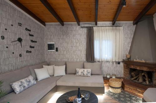 a living room with a couch and a fireplace at PLATS Traditional Living in Dáfni