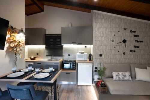 a kitchen and living room with a table and a couch at PLATS Traditional Living in Dáfni