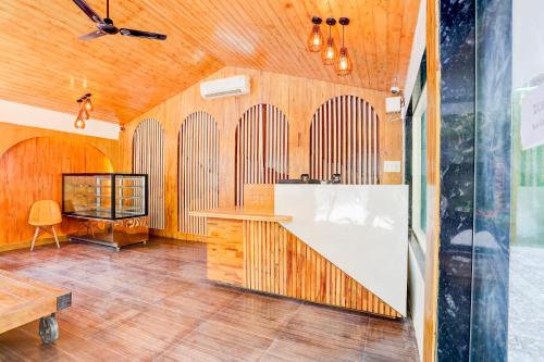 a room with wooden walls and a wooden floor at Staybook The Rudveda Resort - Free High Tea near Pool Area in Rāmnagar