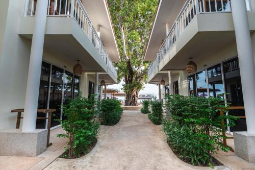 a courtyard of a building with trees and plants at LOVE beach club Koh Samui in Chaweng