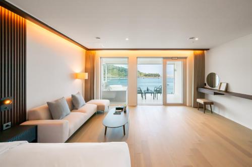 a living room with a couch and a table at Yeosu OANDF Hotel in Yeosu