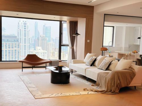 a living room with a white couch and a large window at XinTianDi 3 Bedrooms Newly Luxury Designer Decoration Intelligent Control System in Shanghai