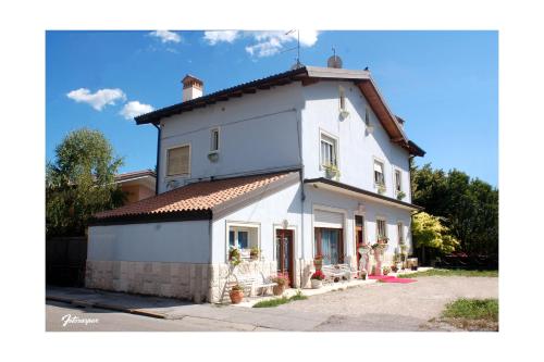 a large white house with a roof at Villa Fiorita in Monfalcone