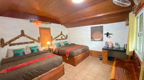 Postel nebo postele na pokoji v ubytování Lung Soi Nguen Homstay Pang Oung