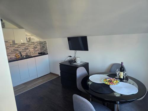 a living room with a table and a kitchen at Vila Kostic in Zlatibor
