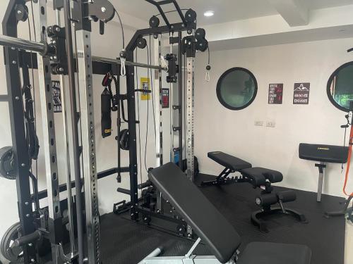 a gym with several tread machines in a room at Skipper's Karon in Karon Beach