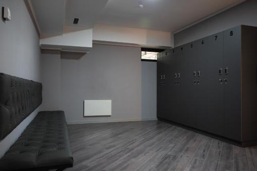 a locker room with a bench in a room at Casablanca Apart Hotel in Bishkek