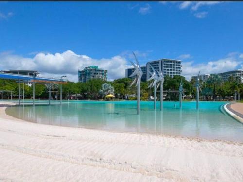 a large pool of water in the middle of a beach at Studio room in Cairns Esplanade! Ocean view! Heart of Cairns in Cairns
