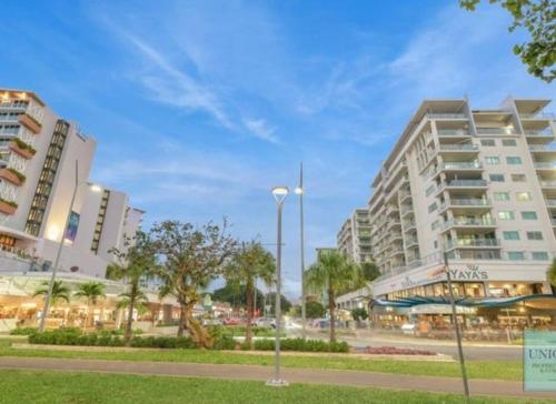 a city with tall buildings and a street light at Studio room in Cairns Esplanade! Ocean view! Heart of Cairns in Cairns