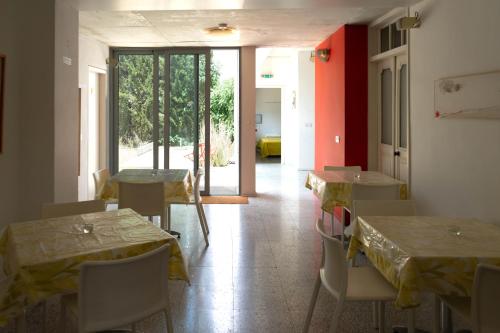 a room with tables and chairs and a room with a hallway at ResArt Traditional House in Nicosia