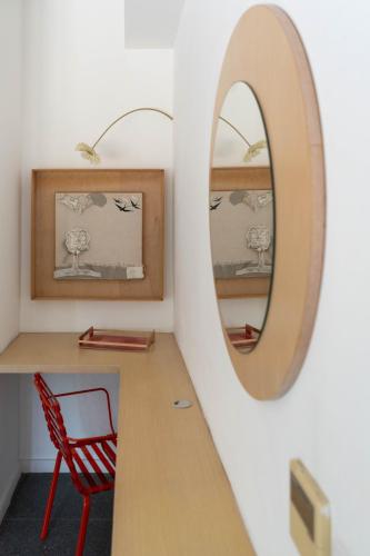 a room with a table and a mirror and a chair at ResArt Traditional House in Nicosia