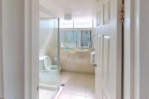 a bathroom with a toilet and a sink at Gemini Resort, 2bedroom Unit19 and carpark Golden Beach, Caloundra in Golden Beach
