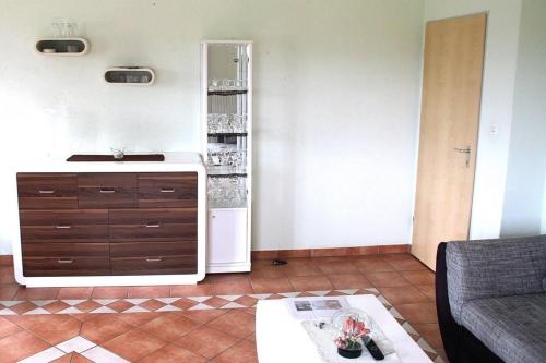a living room with a refrigerator and a table at Ferienwohnung Nr 2, neben einem Bauernhof, Roßhaupten, Allgäu in Roßhaupten