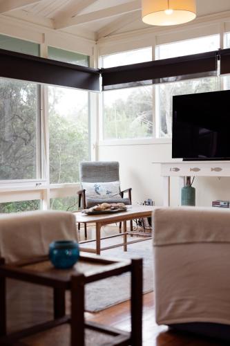 a living room with a couch and a tv at My Seaclusion in Sorrento