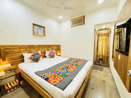 a bedroom with a large bed in a room at Hotel Regency in Amravati