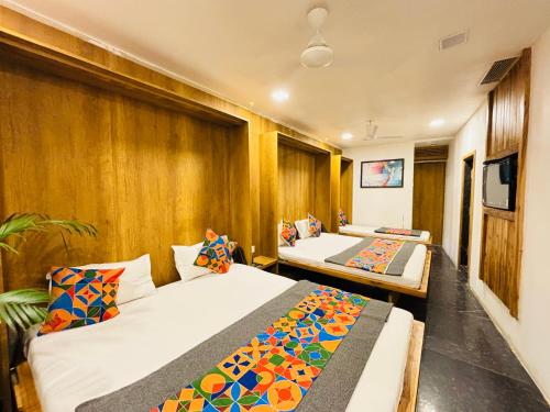 a room with two beds and a tv in it at Hotel Regency in Amravati