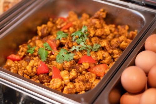 a tray of food with meat and vegetables and eggs at Xiamen Zhongshan Road Pedestrian Street Qulistar Hotel in Xiamen