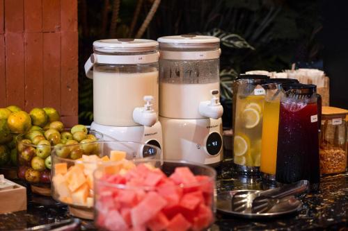 a table topped with jars of juice and fruit at Xiamen Zhongshan Road Pedestrian Street Qulistar Hotel in Xiamen