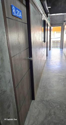 a door in a hallway with a sign on it at Captain Joe Cafe & Hostel in Hua Hin
