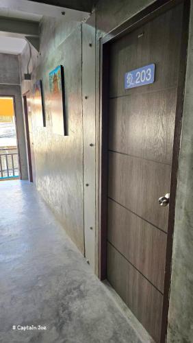 a room with a door with a sign on it at Captain Joe Cafe & Hostel in Hua Hin