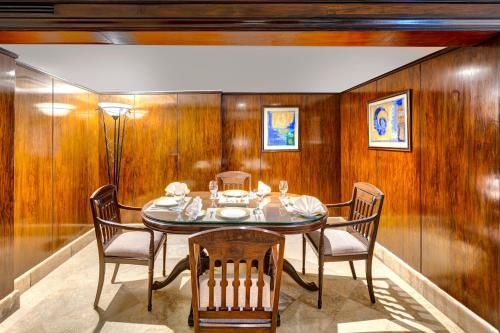 a dining room with a table and chairs at Pearl Continental Hotel, Rawalpindi in Rawalpindi
