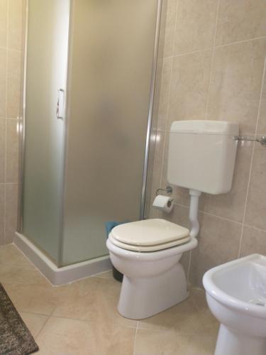 a bathroom with a toilet and a shower at Carini house in Carini