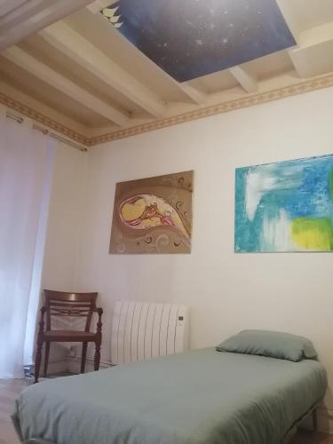 une chambre avec un lit et un tableau au mur dans l'établissement Relais Art Bien-Etre Lumineux Doué en Anjou, à Doué-la-Fontaine